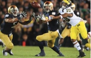 Notre Dame's Manti Te'o (5) and Zeke Motta (17) and Michigan's Jeremy Gallon (10) reach for a batted ball during the game between the Irish and Wolverines on Sept. 22, 2012. Te'o intercepted this pass and the Notre Dame defeated Michigan 13-6.